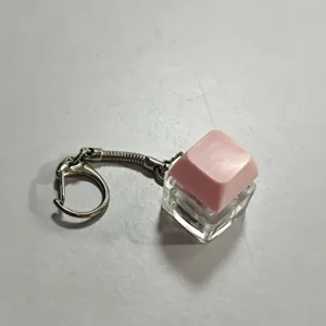Pink mechanical keyboard keycap keychain fidget toy, decompression fingertip clicker pendant detail view.