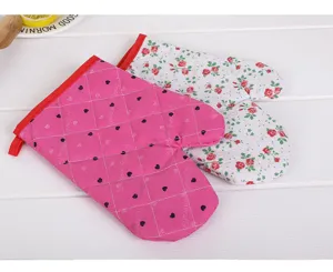 Detail shot of heat-resistant kitchen oven mitts featuring cute floral and heart print patterns.
