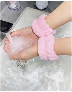 Pink fluffy face washing wristbands, soft absorbent sweat bands for daily skin care and sports use.