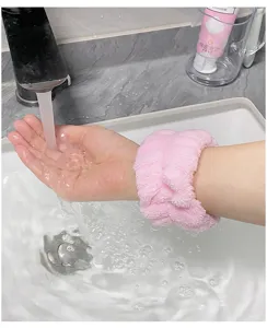 Soft pink plush face washing wristbands absorbent spa wrist wash bands for daily skincare routine.
