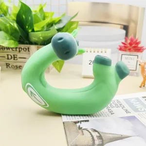 Detailed shot of quirky green stress relief squeeze toy with swirl logo on tabletop setup.