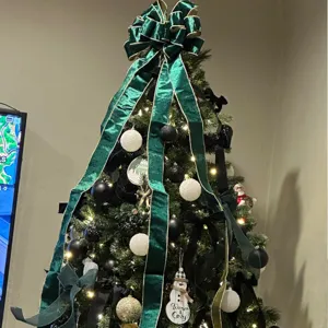 Extra large green velvet Christmas tree bow top ornament for holiday festive party decor.