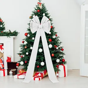 Detail view of large white velvet Christmas bow with long tails for holiday tree decoration.