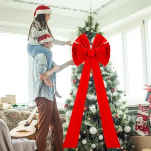 Giant red velvet Christmas tree bow with long streamers for holiday indoor outdoor decor