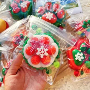 Christmas squishy toy detail, cute cake and wreath design with red berries and snowflake.