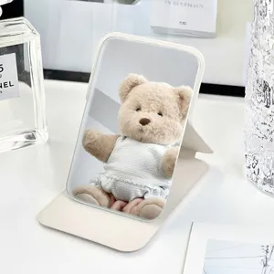 Portable desktop makeup mirror with solid color PU leather folding stand for daily use.