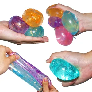 Close-up detail of glitter apple squishy toy showing stretchy texture and vibrant colors.