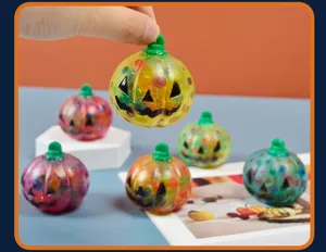 Halloween pumpkin squeeze toy with colorful beads inside for stress relief and fun play.