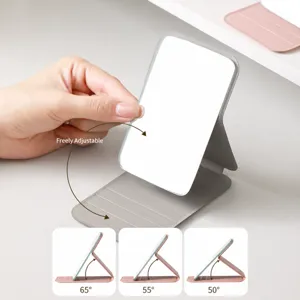 Portable folding makeup mirror with multi-slot stand for desktop dorm use, adjustable angle.