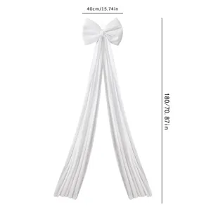 White velvet Christmas bow pendant with long trailing ribbons, elegant holiday tree decor.