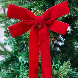 Large red velvet bow for Christmas tree decoration, home room party and wedding holiday styling.