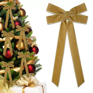 Gold velvet Christmas tree bow detail showing soft plush texture and elegant long ribbon streamers.
