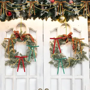Ghirlanda di Natale con fiocchi in velluto e catene di perle per porta e decorazione albero.