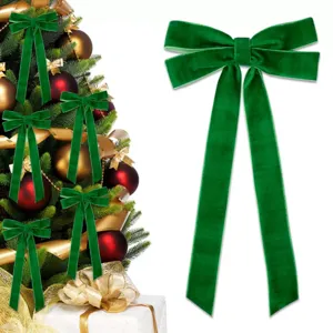 Detailed view of the large green velvet Christmas bow showcasing soft texture and hanging design.