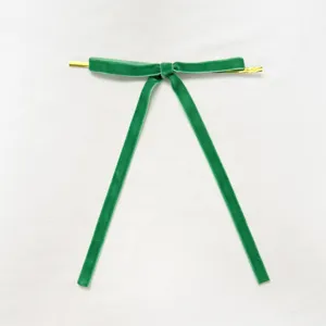 Green velvet twist tie ribbon detail showing soft texture and gold wire ends for decoration.
