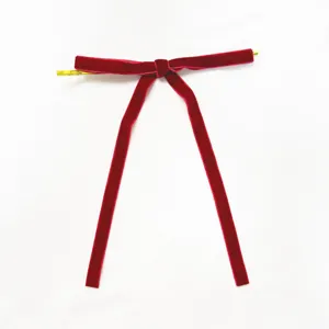 Red velvet ribbon bow twist tie for Christmas tree decoration and holiday festive hanging.