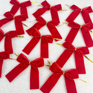 Red velvet bows with golden twist ties detail, perfect for Christmas tree decor and gift wrapping.