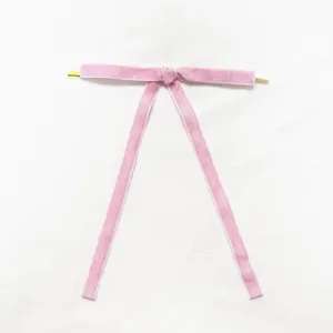 Detailed view of the pink velvet bow decoration, perfect for Christmas tree holiday craft.