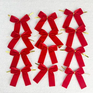 Detail shot of red velvet Christmas bows with golden twist ties, perfect for tree decor.