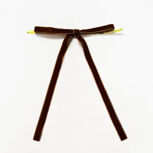 Brown velvet bow hanging ornament for Christmas tree decor, elegant holiday party accessory.