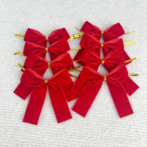 Red velvet Christmas bow decorations with gold twist ties for tree and gift packaging.