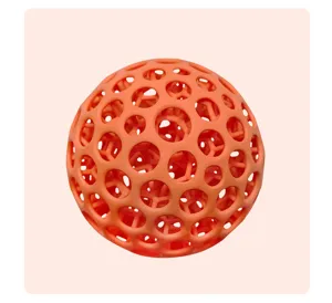 Close up detail view of the 3D printed orange hollow mesh stress ball with flexible lattice structure.
