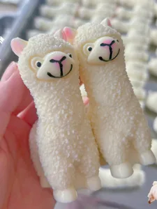 Cute white alpaca squeeze toy for stress relief, soft tactile sensory toy detail view.