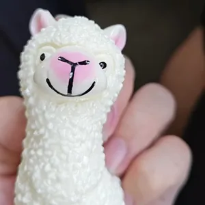 Close-up detail of the cute white alpaca squeeze toy, soft texture and lovely expression.