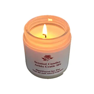 Hand-poured soy wax scented candle in a clear glass jar for cozy home relaxation and decor.
