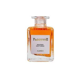 Square glass bottle reed diffuser with orange liquid, elegant home air freshener display.