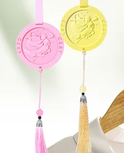 Detailed view of scented plaster hanging tablets with fairy relief and delicate tassels.