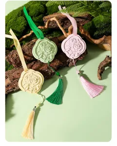 Close-up of elegant gypsum aromatherapy stone hanging pendant featuring delicate rose relief and tassel.