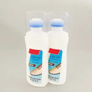 Dettaglio di due flaconi di detergente per scarpe con testina a spugna blu per scarpe bianche.