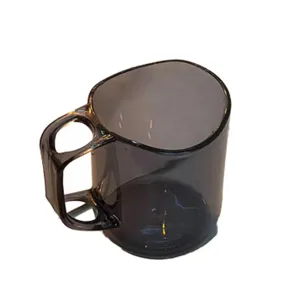 Tazza per sciacquo curva trasparente con manico, dettaglio di stoviglie moderne.