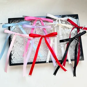 Colorful ribbon bows with long tails for DIY crafts, gift wrapping, and holiday decorations.