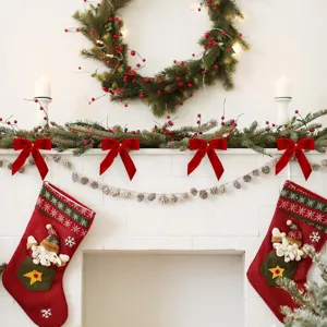 Detailed shot of red velvet Christmas bows hanging on a festive fireplace mantel garland.