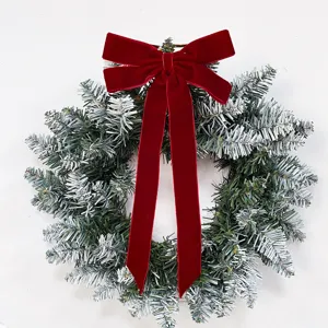 Christmas frosted pine wreath with red velvet bow for holiday party home indoor decor