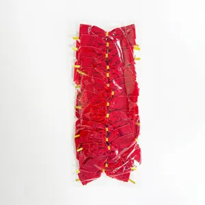 Detail view of red velvet Christmas bows packed neatly in a clear bag for tree decor.