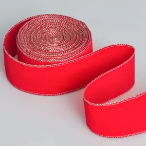 Detailed view of red velvet ribbon with gold wire edge, ideal for Christmas decoration.
