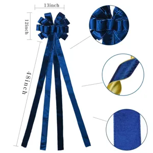 Extra large blue velvet Christmas tree bow with gold trim and long hanging ribbons for holiday decor.