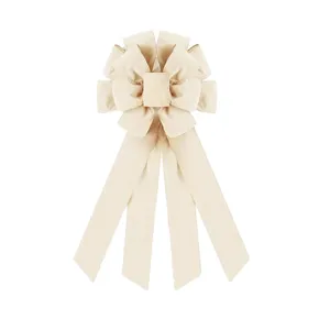 Detail shot of large beige fabric bow, textured ribbon ornament for holiday tree and home decor.