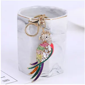 Rhinestone parrot keychain metal bag charm detailed view showing vibrant crystal stones.
