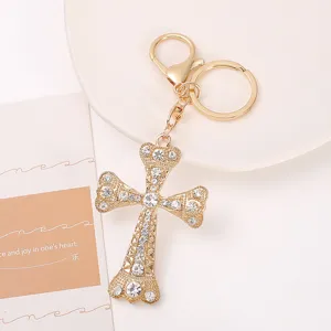 Exquisite gold rhinestone cross keychain and bag pendant, dazzling fashion accessory gift.