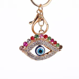 Stunning gold-tone metal evil eye rhinestone keychain bag charm closeup detail view.