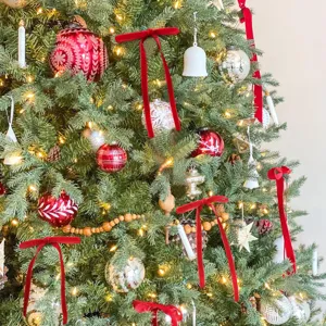 Red velvet Christmas tree bows and holiday hanging ornaments for home decor and festive styling.