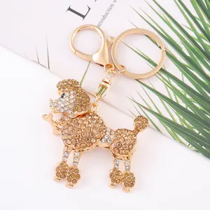 Gold rhinestone poodle keychain detail shot, sparkling crystal dog bag pendant key ring.
