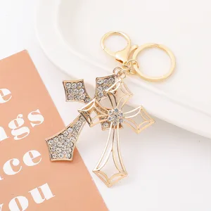 Gold rhinestone double cross keychain metal bag pendant charm accessory details close-up
