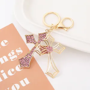 Close up view of the stylish metal rhinestone cross keychain showing intricate details.
