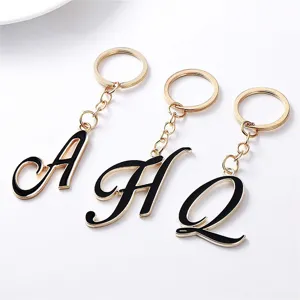 Gold-rimmed metal alphabet letter keychain pendant featuring black enamel style details.