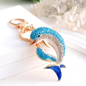 Metal rhinestone dolphin keychain detail shot, premium crystal parent-child design ornament.